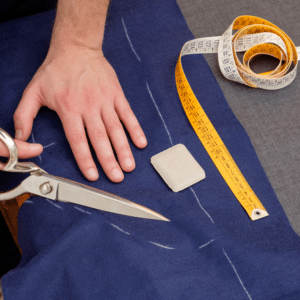 Tailor scissors cutting with measuring tape